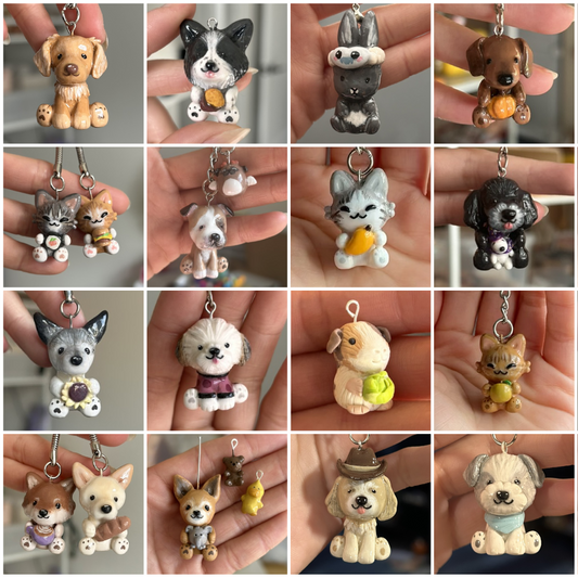 Collection of small cat and. dog figurines held in hands against a neutral background